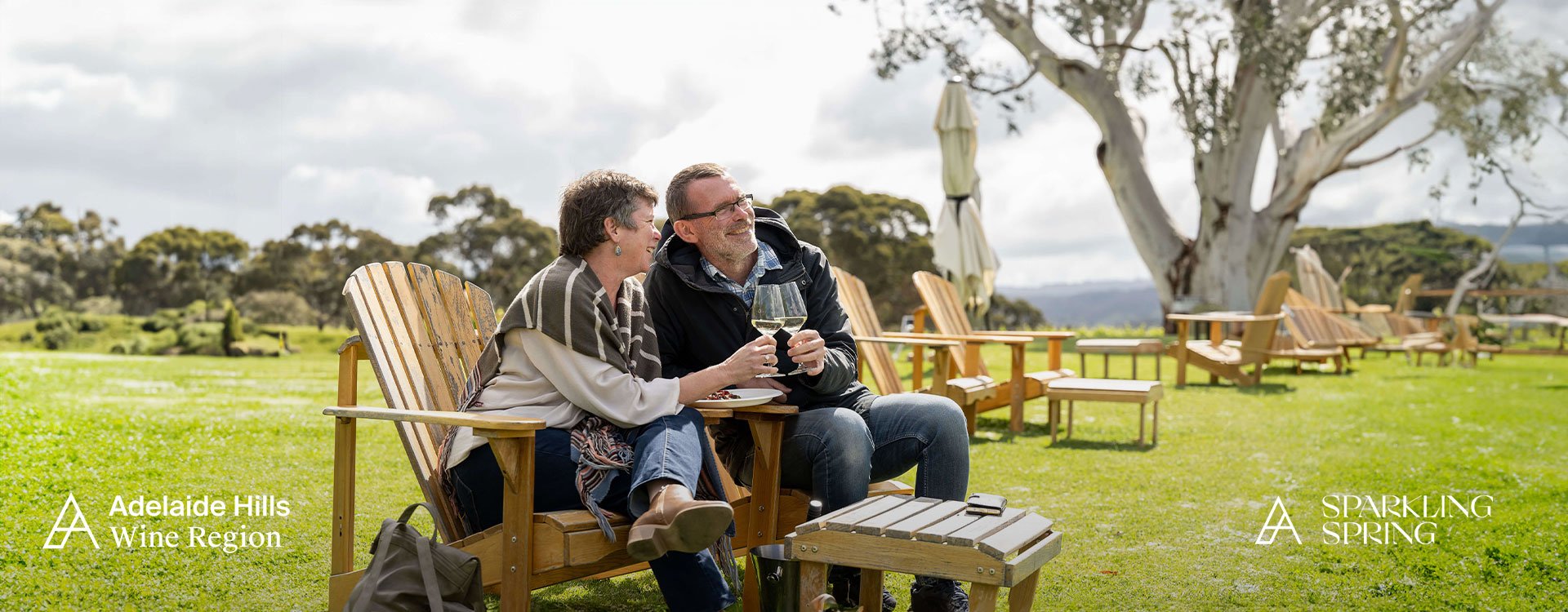 Couple cheersing a glass of white wine at the Nepenthe Cellar Door