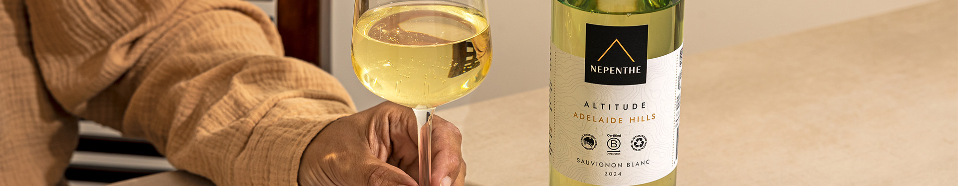 Bottle of nepenthe sauvignon blanc and glass of wine