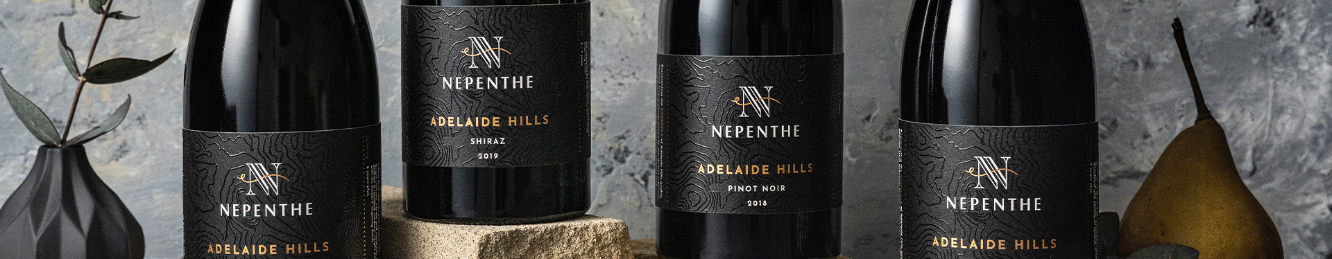 Pinnacle Nepenthe Bottles Lined Up next To Each Other Zoomed In to the Bottle Labels